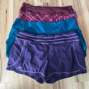 3 pairs of Athleta fitness shorts. Purple and pink are L. Blue is XL.